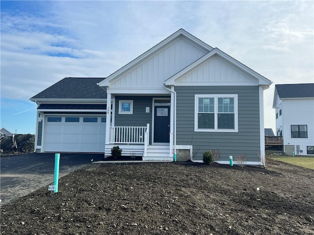 view of front of property featuring a porch and a garage