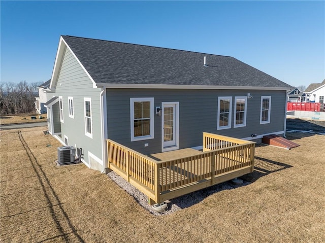 rear view of property featuring a wooden deck, a yard, and central AC unit