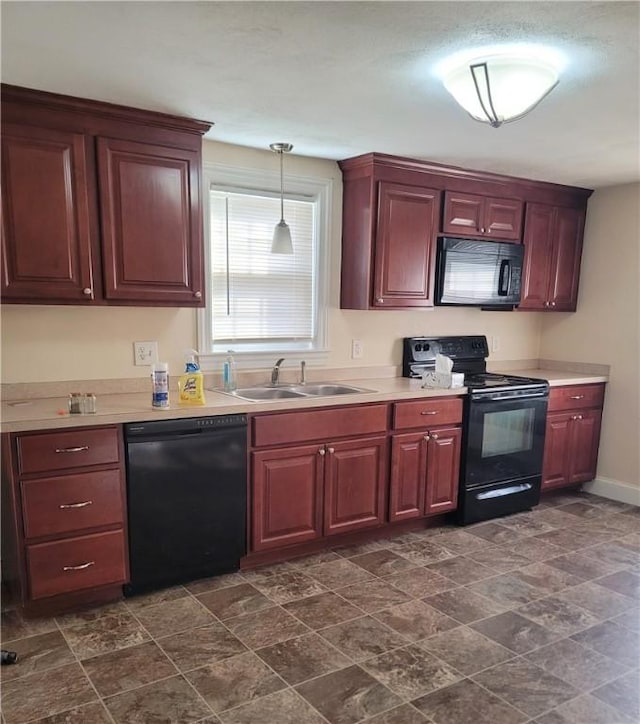 kitchen with black appliances, decorative light fixtures, and sink