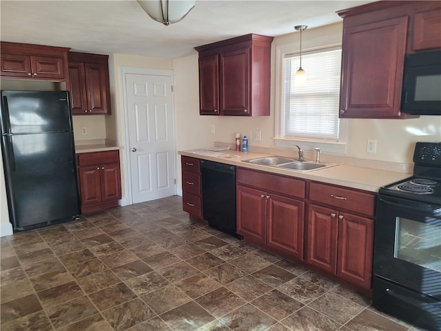 kitchen with black appliances, sink, and hanging light fixtures