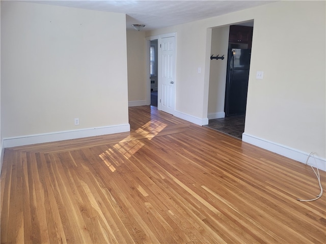 empty room with hardwood / wood-style flooring