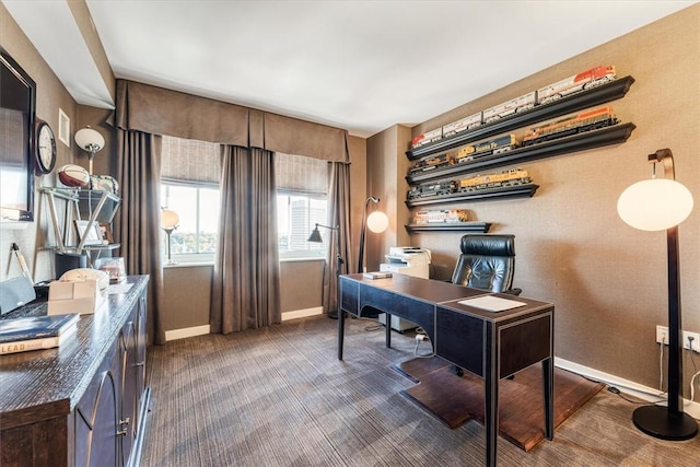 office featuring baseboards and dark colored carpet