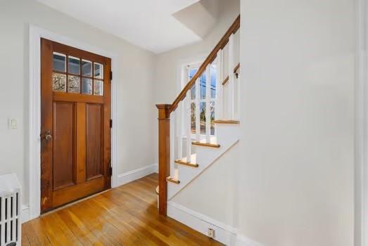 entryway featuring light wood-type flooring and radiator heating unit