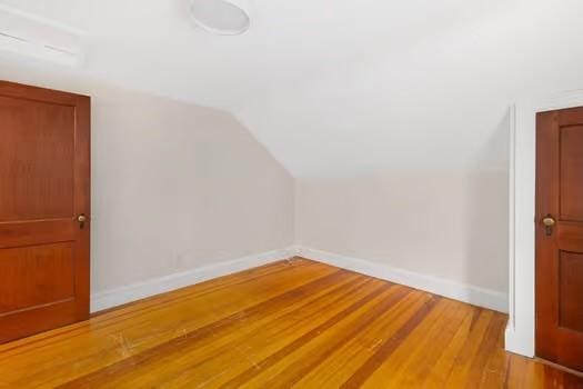 bonus room featuring light hardwood / wood-style flooring and vaulted ceiling