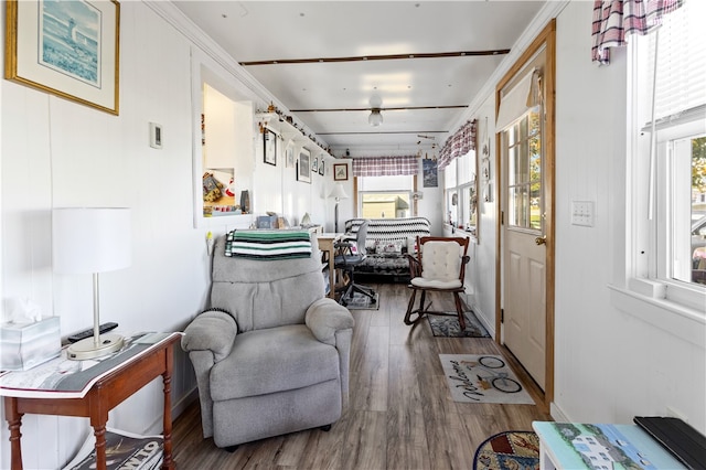 sitting room with crown molding, hardwood / wood-style flooring, and plenty of natural light