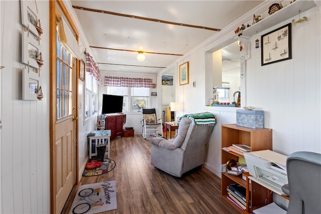 living room featuring crown molding, wooden walls, and dark hardwood / wood-style flooring