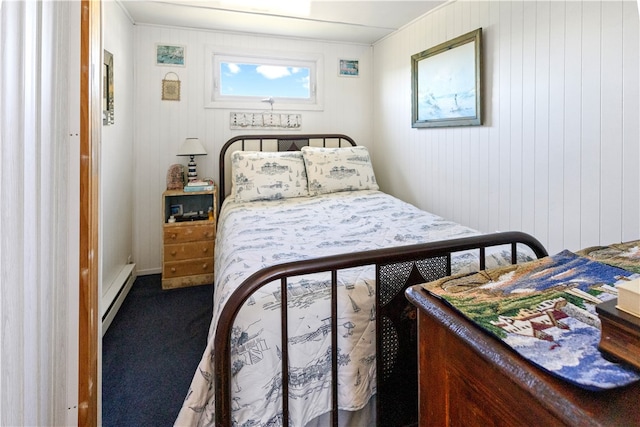 carpeted bedroom featuring wood walls and a baseboard radiator