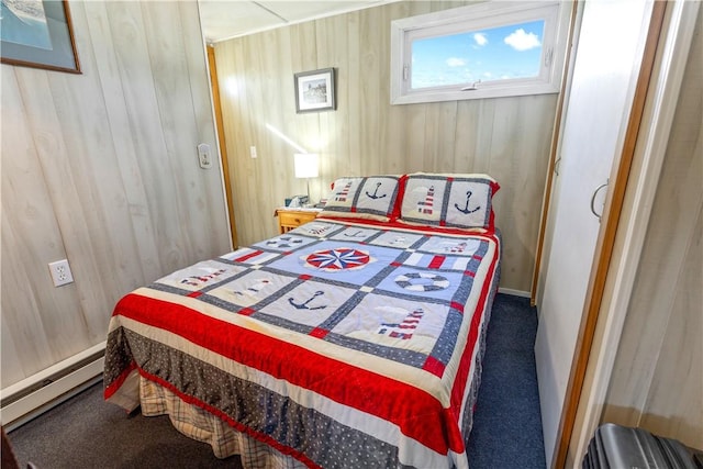 carpeted bedroom with wood walls and a baseboard radiator