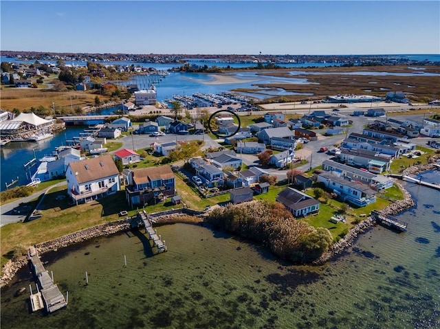 drone / aerial view featuring a residential view and a water view