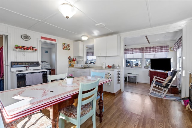 kitchen with white cabinets, sink, dark wood-type flooring, and white range with electric cooktop