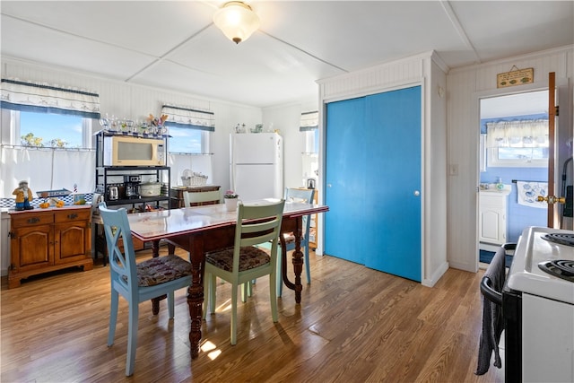 dining room with wood-type flooring and ornamental molding