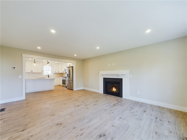 unfurnished living room featuring light hardwood / wood-style flooring