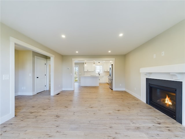 unfurnished living room featuring light hardwood / wood-style floors