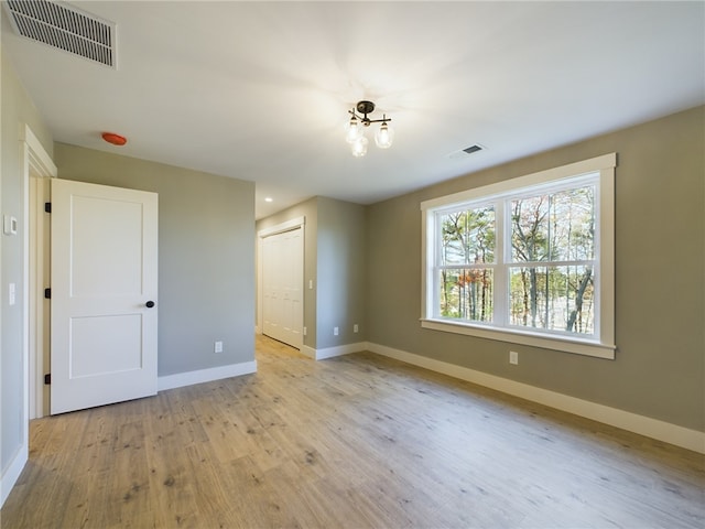 spare room with light hardwood / wood-style floors