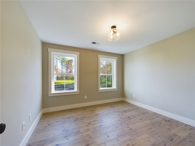 unfurnished room with light wood-type flooring