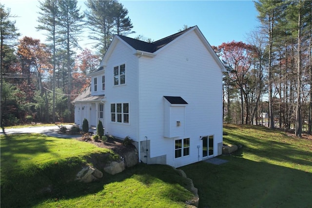 view of home's exterior featuring a lawn