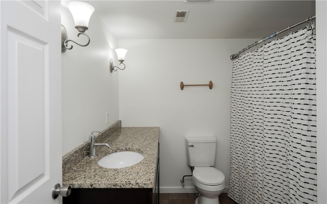 bathroom with vanity, toilet, and tile patterned floors