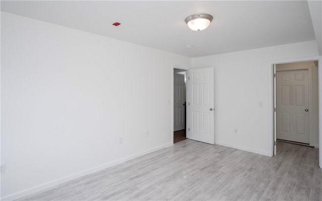 unfurnished room with light wood-type flooring