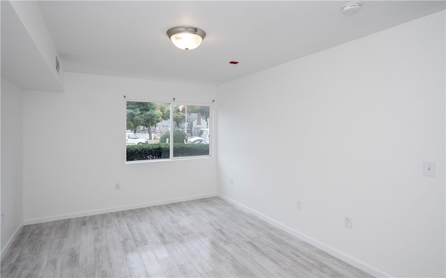 unfurnished room with light hardwood / wood-style floors