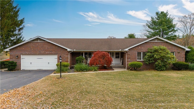 single story home with a garage and a front lawn