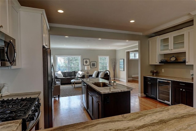 1402 Hunting Hill Dr, Cumberland, RI 02864 - kitchen with a sink, beverage cooler, light wood-style flooring, stainless steel appliances, and open floor plan