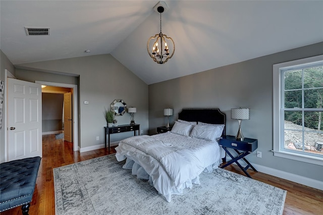 bedroom with dark wood-type flooring, lofted ceiling, and multiple windows