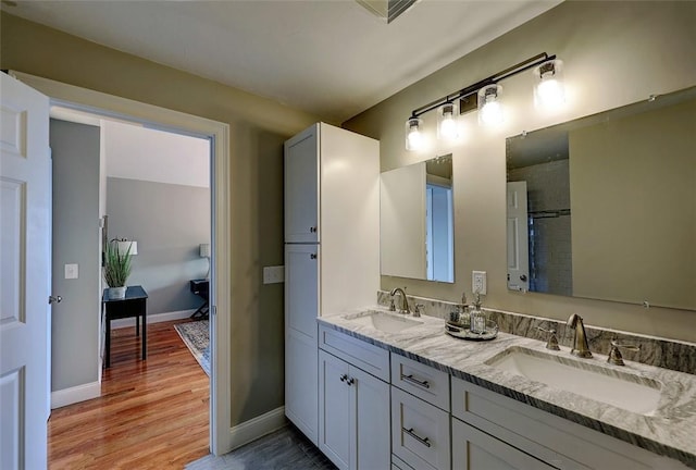 1402 Hunting Hill Dr, Cumberland, RI 02864 - full bath featuring baseboards, a sink, wood finished floors, and double vanity