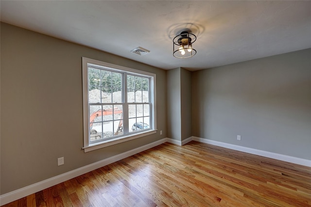 spare room with light hardwood / wood-style floors