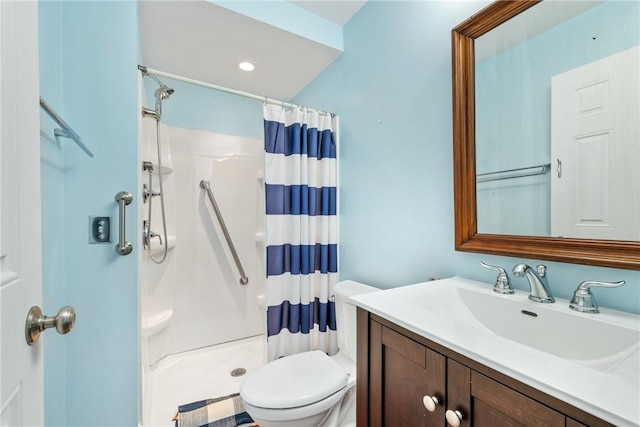 bathroom featuring a shower with curtain, vanity, and toilet