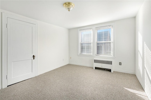 carpeted empty room with radiator