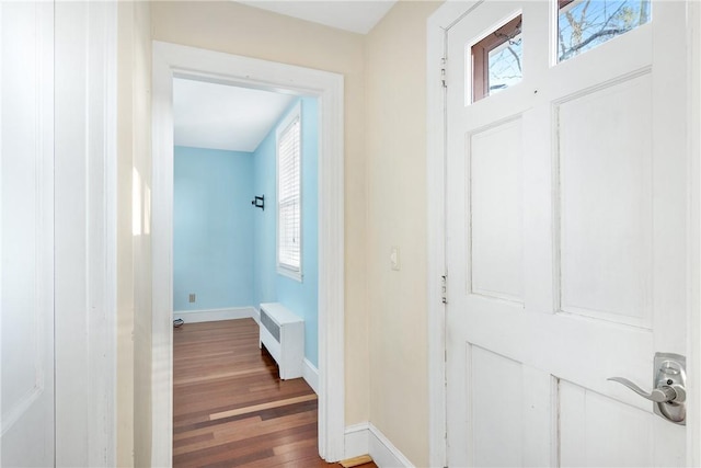 foyer featuring hardwood / wood-style floors and radiator heating unit