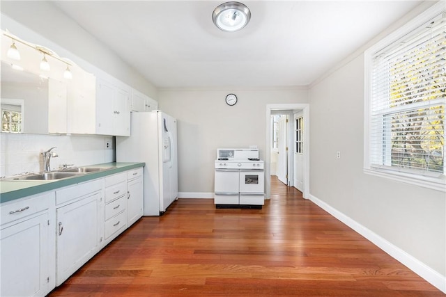 kitchen featuring white cabinets, white appliances, sink, and a wealth of natural light