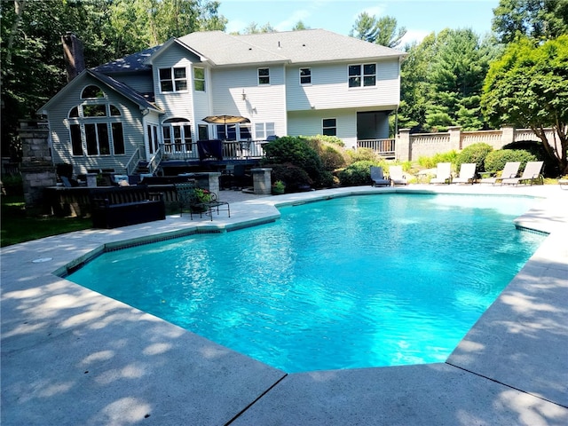 view of swimming pool featuring a patio area and a wooden deck