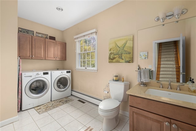 clothes washing area featuring a baseboard radiator, sink, washer and clothes dryer, and light tile patterned flooring