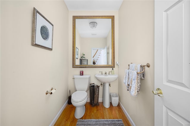 bathroom with sink, wood-type flooring, and toilet