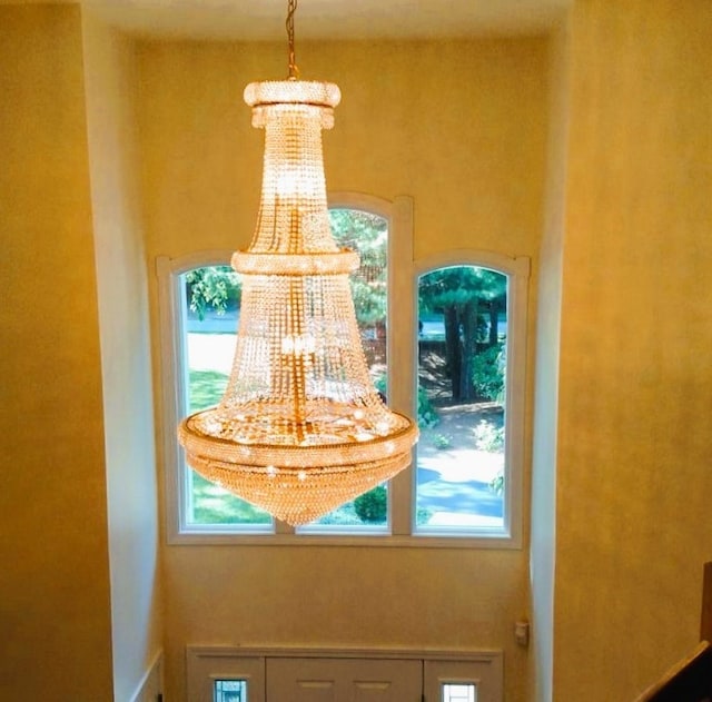 interior details featuring an inviting chandelier