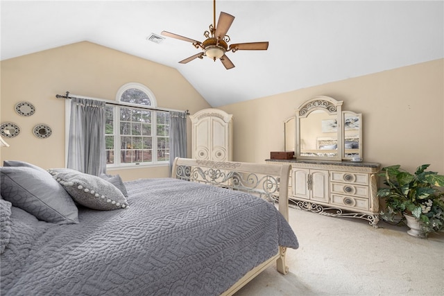 carpeted bedroom with ceiling fan and vaulted ceiling