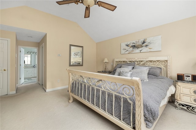 carpeted bedroom with ensuite bathroom, vaulted ceiling, and ceiling fan