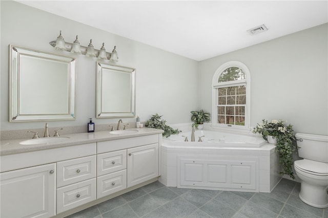 bathroom with vanity, a bathtub, toilet, and tile patterned flooring