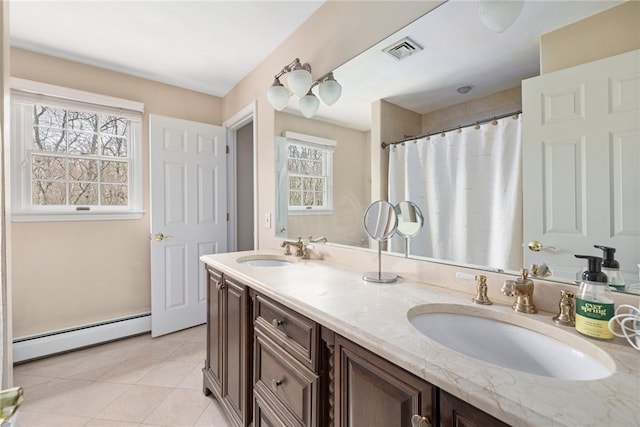 bathroom featuring vanity, a wealth of natural light, tile patterned flooring, and a baseboard heating unit