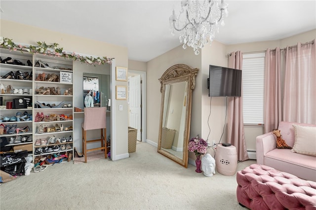 carpeted bedroom featuring an inviting chandelier