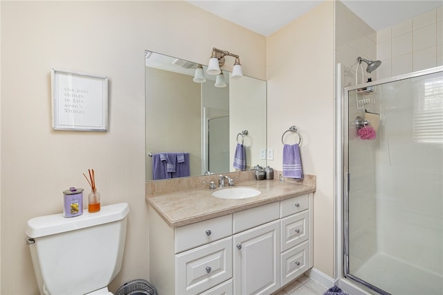 bathroom with vanity, toilet, a shower with shower door, and tile patterned flooring