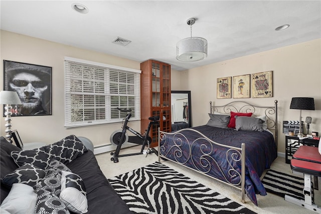 bedroom featuring a baseboard radiator and light colored carpet