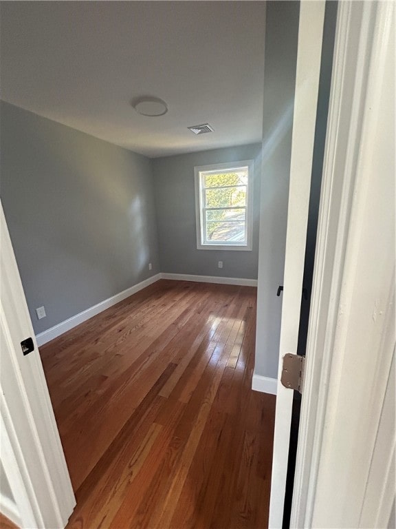 empty room with hardwood / wood-style floors