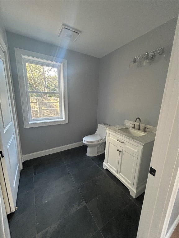 bathroom featuring vanity, toilet, and tile patterned flooring