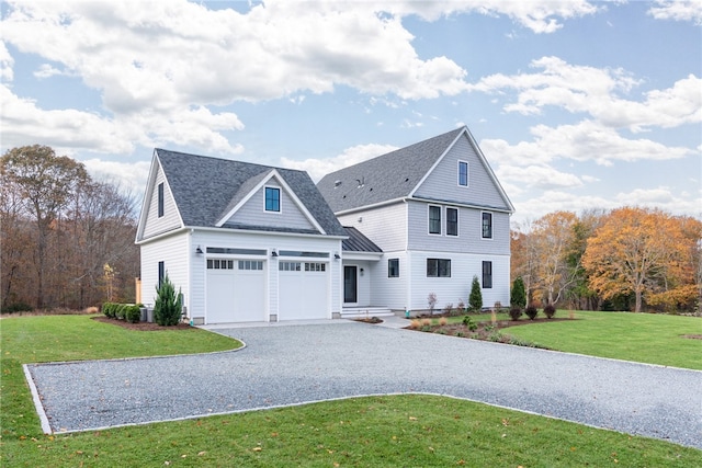 view of front of home with a front yard and a garage