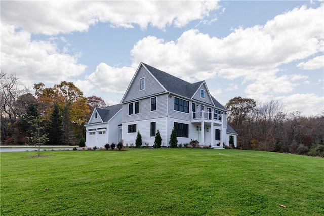 view of front facade with covered porch, a front lawn, and a garage