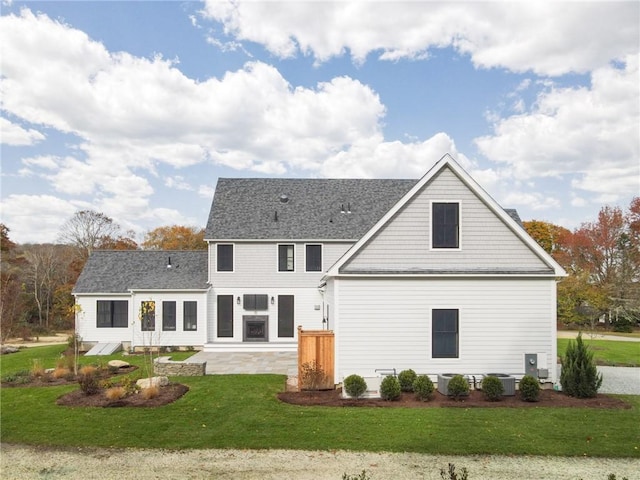 416 Bridgetown Rd, South Kingstown, RI 02874 - rear view of house featuring roof with shingles, a patio area, a yard, and cooling unit