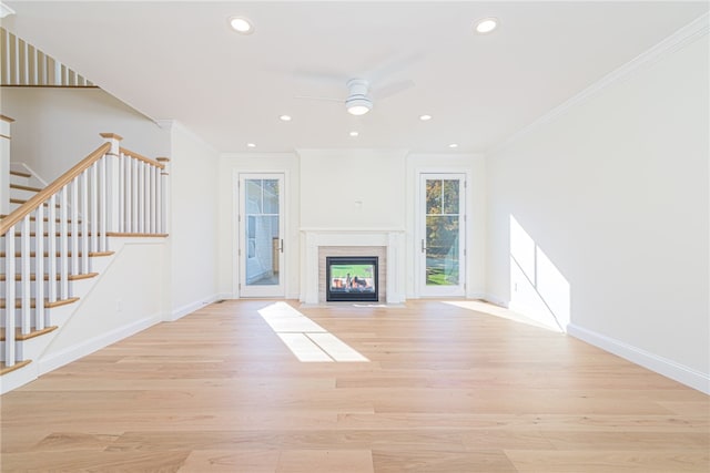 unfurnished living room featuring crown molding, light hardwood / wood-style flooring, and ceiling fan