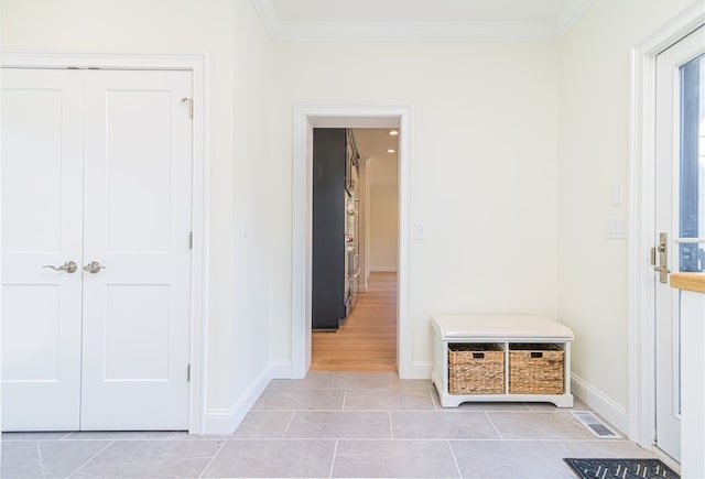 mudroom featuring ornamental molding and light tile patterned flooring